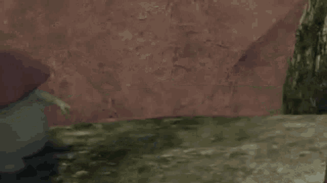 a person is laying on the ground in a video game with a pink background .