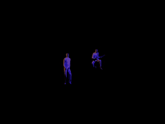 a man is playing a guitar while another man is standing in the dark