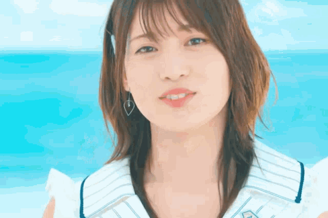 a close up of a woman 's face with a blue background