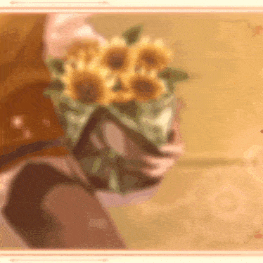 a woman is holding a bouquet of sunflowers in her hands