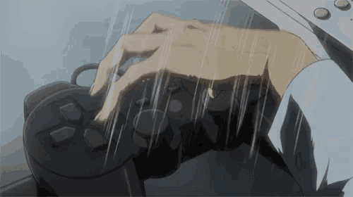 a hand is pressing a button on a black controller