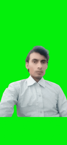 a man in a white shirt is posing for a picture on a green screen .
