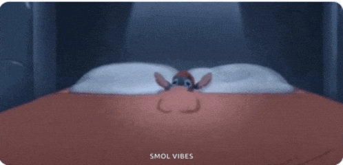 a cartoon of stitch laying on a bed with the words smol vibes below him