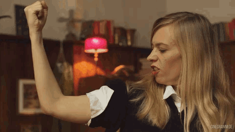 a woman with a fist in the air and the words cinegramm.de below