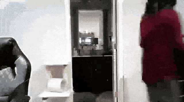 a blurred image of a person standing in a room