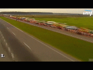 a row of cars are driving down a highway with a sign that says john