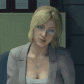 a woman with blonde hair and glasses is sitting at a desk