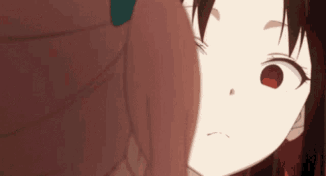 a close up of a girl 's face with red eyes .