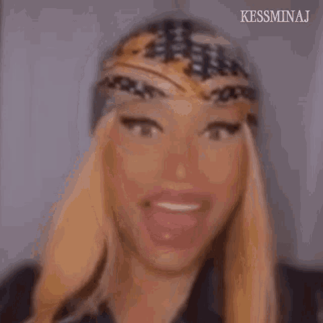 a close up of a woman wearing a bandana on her head and smiling .
