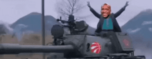 a man is riding on the back of a tank .