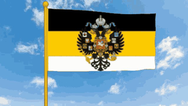 a black yellow and white flag with a black eagle on it