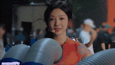 a woman with a microphone on her head is surrounded by a bunch of tubes and says aspagifs