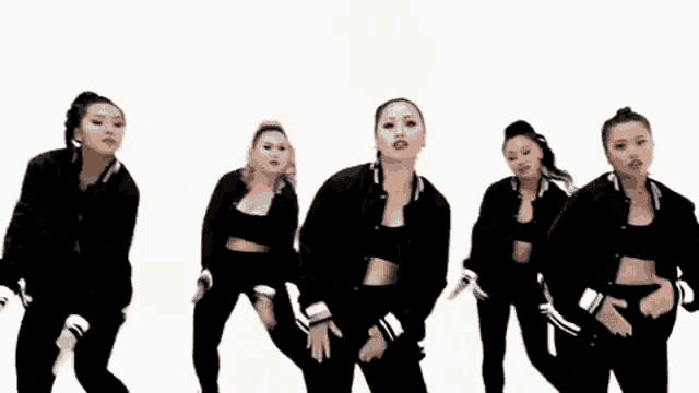 a group of young women are dancing together in a line on a white background .