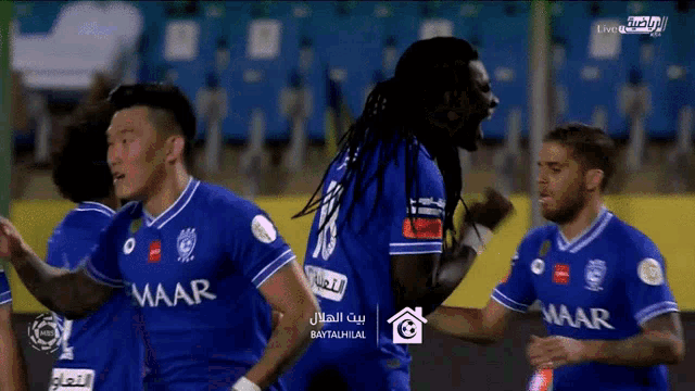 a group of soccer players wearing blue jerseys with maar written on them