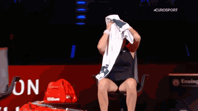 a person covering their face with a towel with eurosport on the bottom right