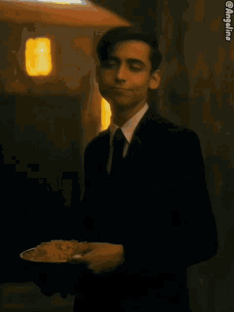 a man in a suit and tie is holding a plate of rice and the caption says context-rice