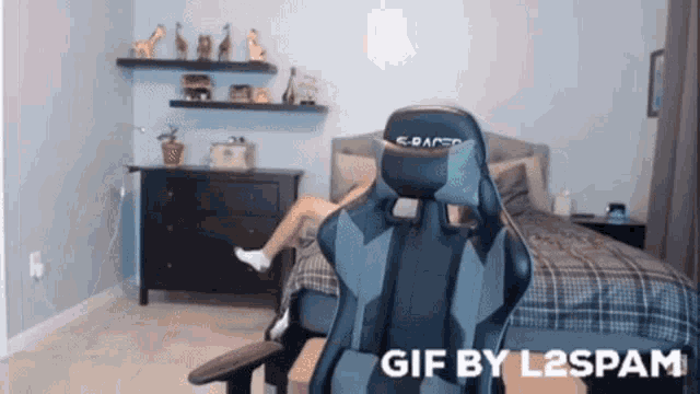 a gif by l2spam shows a person sitting in a chair in a bedroom