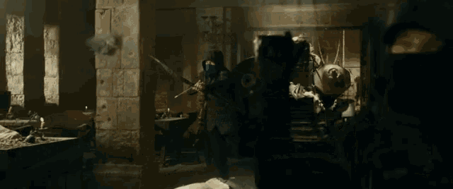 a man wearing a mask is holding a sword in a dark room