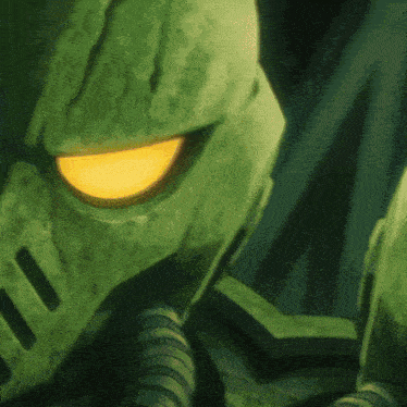 a green robot with a yellow eye is looking at the camera