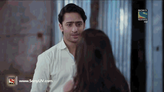 a man and a woman are looking at each other on a sony tv show