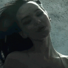 a close up of a woman 's neck and face with her eyes closed
