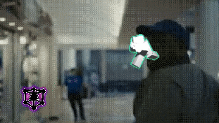 a blurred image of a man wearing a mask and a hat