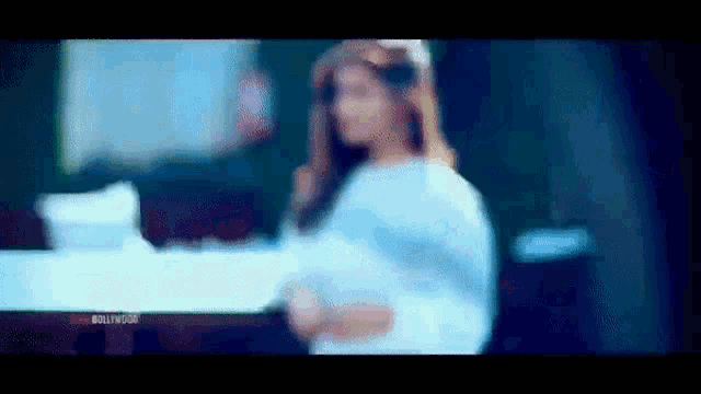 a blurry picture of a woman with the word bollywood on the bottom left