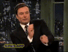 a man in a suit and tie is clapping his hands with a gif app watermark