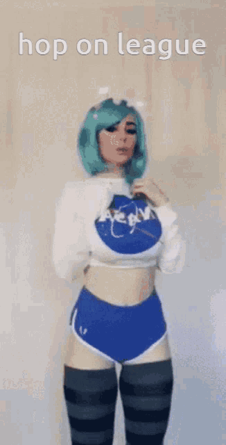 a woman with green hair is wearing a nasa sweater and blue shorts