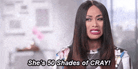 a woman with long hair is making a funny face and saying she 's 50 shades of cray !