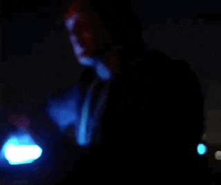 a man in a blue robe is holding a blue light