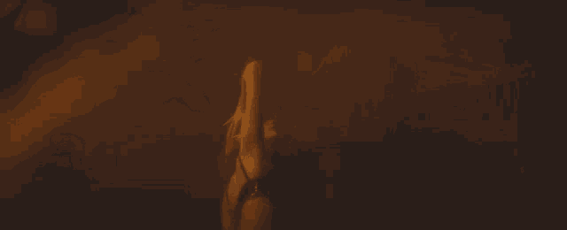 a woman in a white dress is standing in a dark room holding her hair .
