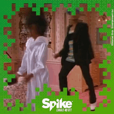 two people are dancing in front of a green background that says spike canale 49 dtf