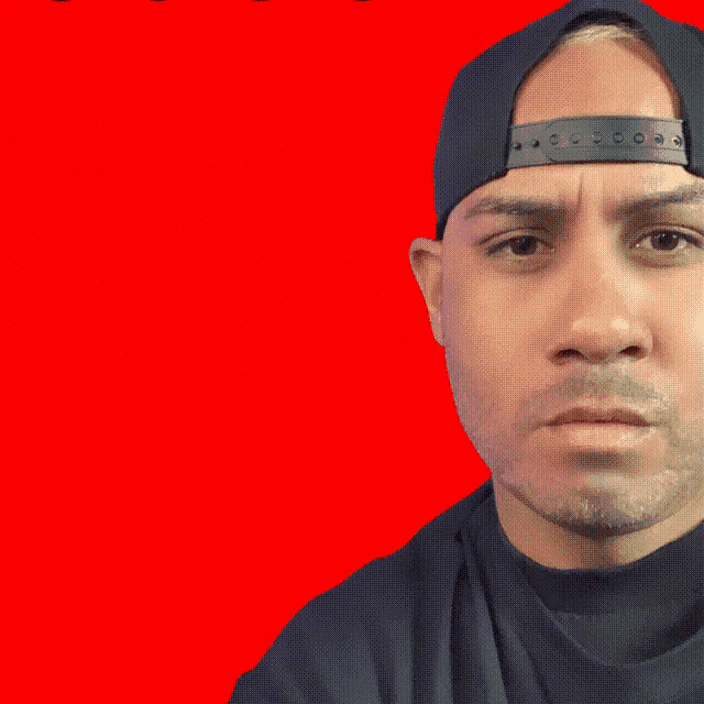a man wearing a hat stands in front of a red background that says judo