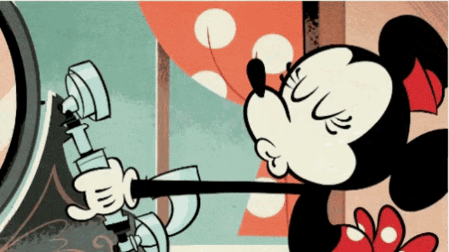 a cartoon of minnie mouse holding a microphone