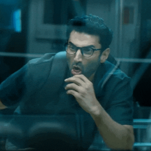 a man wearing glasses and a backpack is screaming
