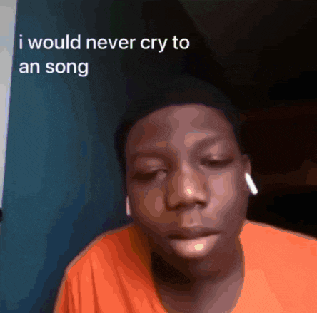 a young man wearing an orange shirt says he would never cry to a song