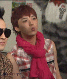 a man wearing sunglasses and a pink scarf has the name oxxcherryz on the bottom
