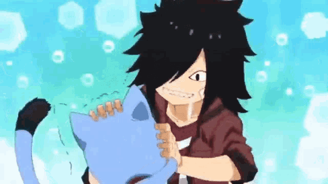 a boy with long hair is holding a blue cat in his arms