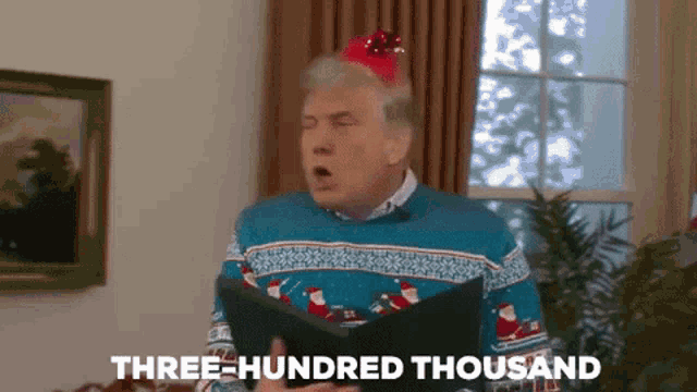 a man in a christmas sweater is singing three hundred thousand .
