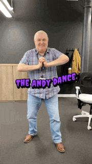a man in a plaid shirt is dancing with the words the andy dance behind him