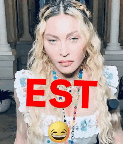 a close up of a woman 's face with the word est in red