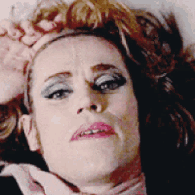 a close up of a woman making a face