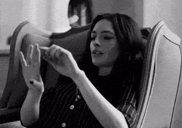 a black and white photo of a woman in a striped shirt