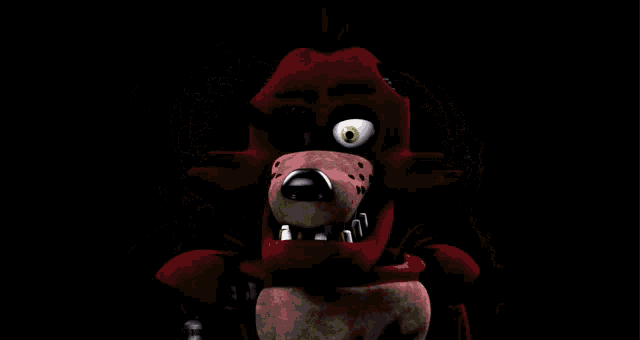 a red teddy bear with a green eye is surrounded by a green rabbit