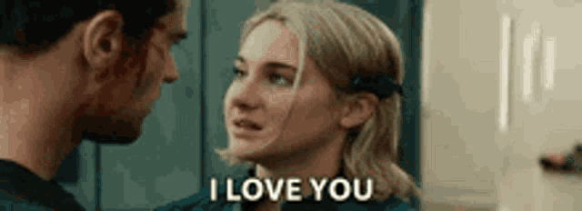a man and a woman are looking at each other and the woman says `` i love you '' .