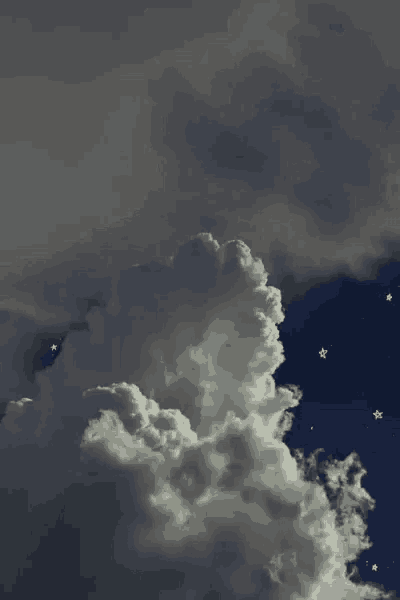 a cloudy sky with a shooting star in it