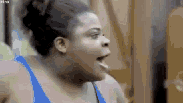 a close up of a woman 's face with her mouth open