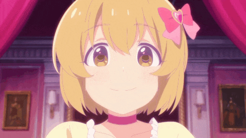a girl with blonde hair and a pink bow on her hair