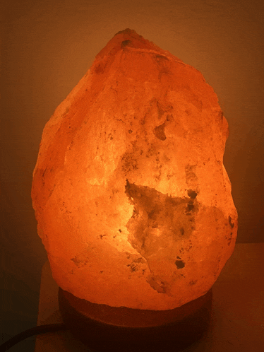 a salt lamp is lit up in the dark